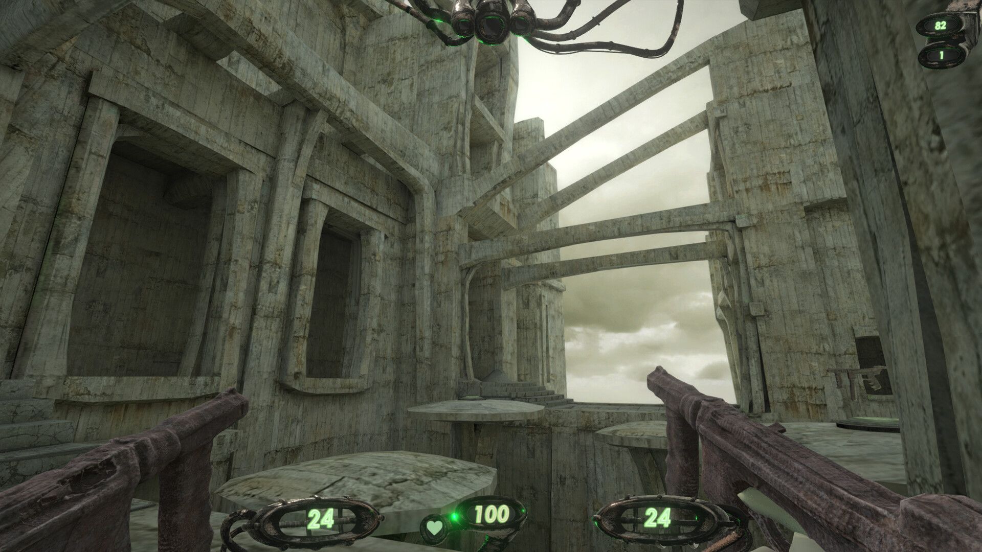 The player holds two machine guns while looking at a concrete city with brutalist architecture. - 1