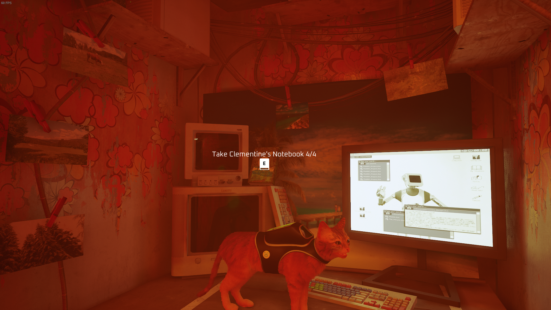 The cat of Stray looks at Clementine&rsquo;s notebook.