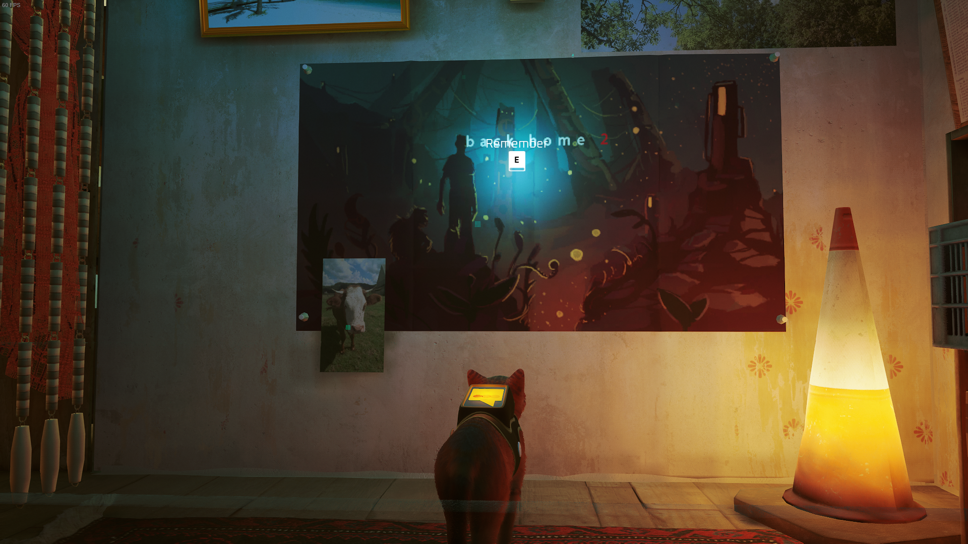 The cat looks at a poster in Momo&rsquo;s room in Stray.