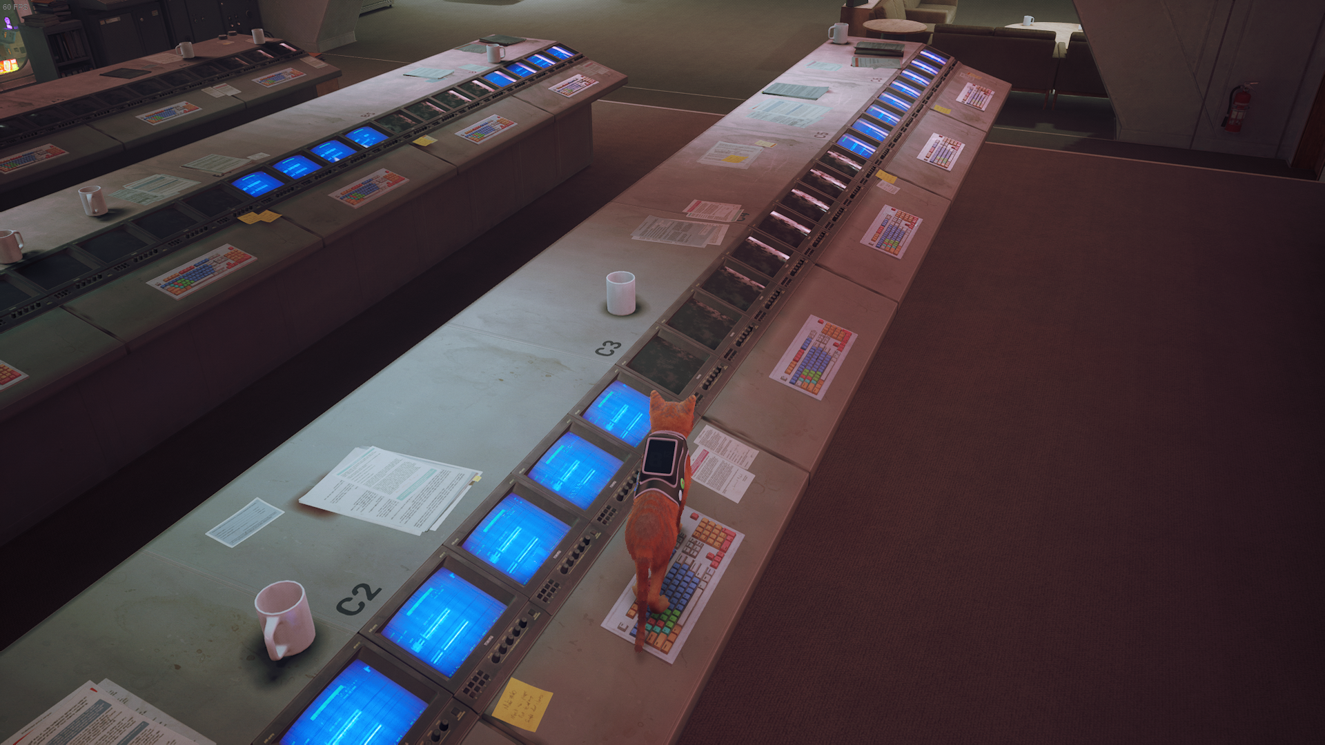 The cat of Stray stands on a keyboard to turn a computer on in the Control Room.