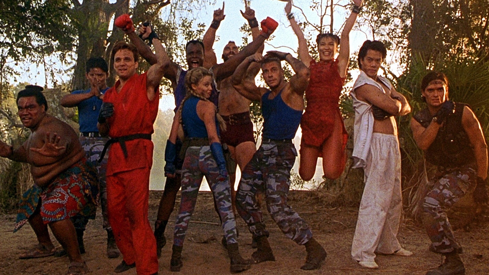 The main cast of the 1994 Street Fighter movie all pulling different poses in front of some trees. - 1