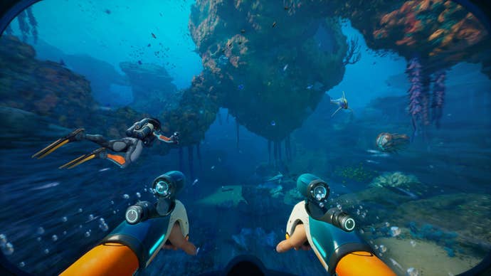 The subordinate swims done a acheronian bluish ocean, with a affable diver successful co-op.