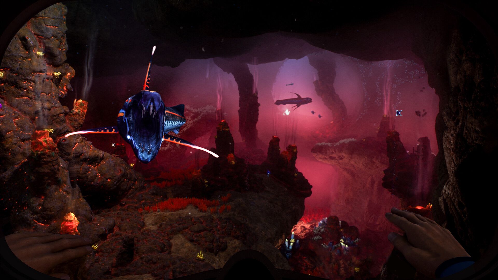 A sharp-toothed fish lunges at the player in a deep cave lit up in red hues. - 1