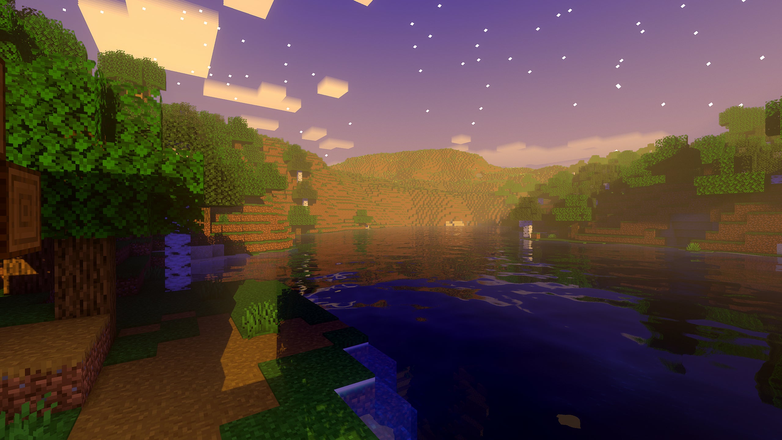 A screenshot of a river in Minecraft, with some trees on either side of the bank and a hill in the distance, taken using SuperDuperVanilla shaders.