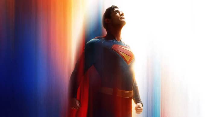 David Corenswet as Superman, he’s flying upwards, various colours blurred behind him.