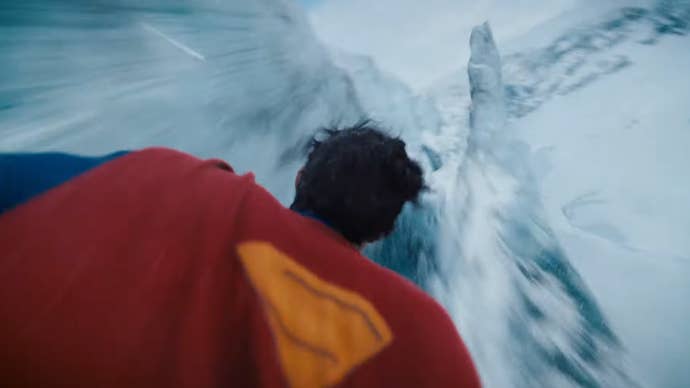 Superman is flying through an icy tundra in Superman (2025).