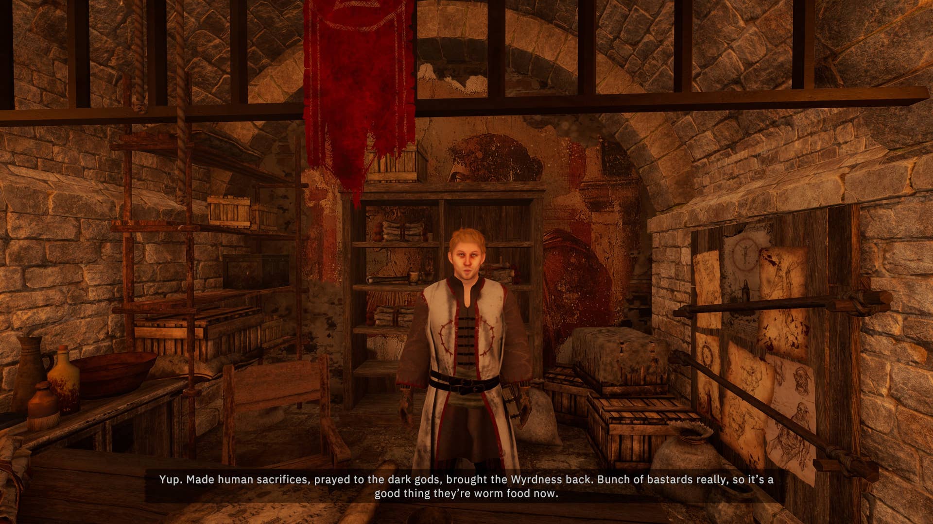 A screenshot from Tainted Grail: Fall of Avalon showing an NPC behind a counter, housed in a kind of brick archway area. He's bathed in a golden glow of light and there are parchment posters stuck to the walls around him. He's talking about a curse in the land.