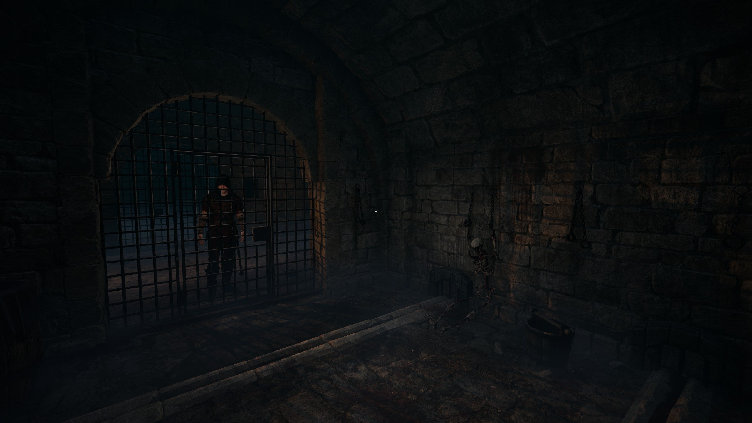 The dark interior of a medieval prison cell, complete with fleshless skeleton, iron grating, and presumably, disease.