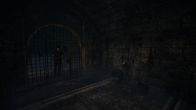 The dark interior of a medieval prison cell, complete with fleshless skeleton, iron grating, and presumably, disease.