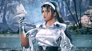A woman dressed in white, with a white hairband and gloves holds out her hand as a small white dove is perched on her fingers