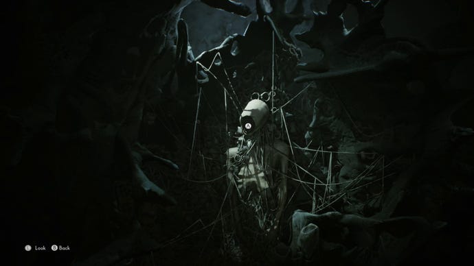 Mariane is looking at a trapped spirit in the world of the dead. It is an emaciated, faceless body held to a wall by many looping strings