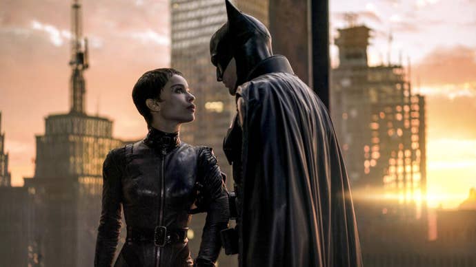 Batman is stood in a building overlooking Gotham at sunset while holding onto Catwoman’s arm in The Batman.