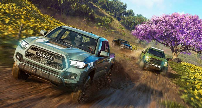 Some cars drive past a cherry blossom tree in The Crew Motorfest.