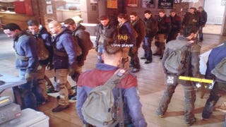 The Division players are queuing to use a laptop