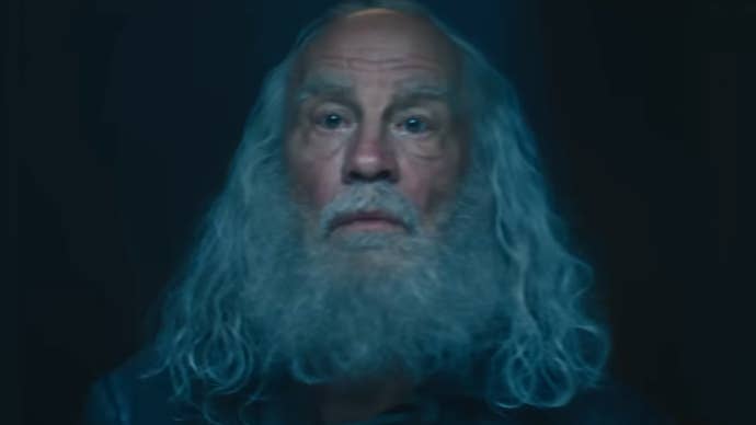 John Malkvoich is stood in a dark area with long hair and beard in The Fantastic Four: First Steps.