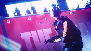 A player character from The Finals holds a sub-machinegun while wearing a smiley face mask on top of her head as an audience of silhouettes looks on.