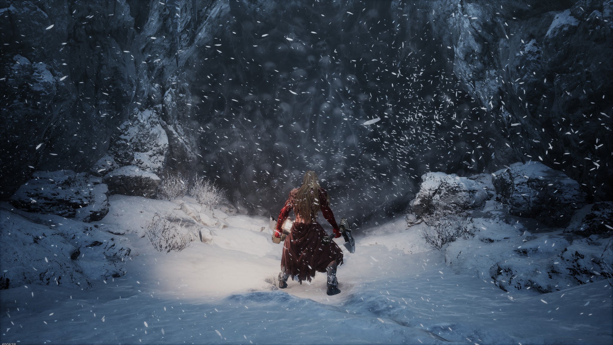 The player stands in the snow outside a cave. - 7