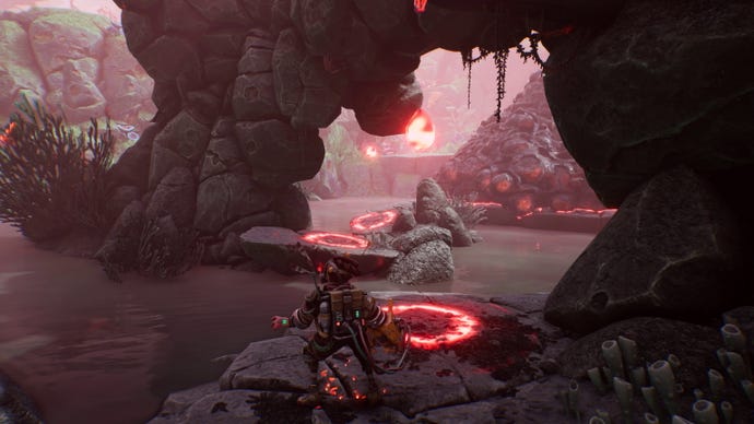 A young woman stands in front of a river with islands in the background covered in gunk in The Gunk