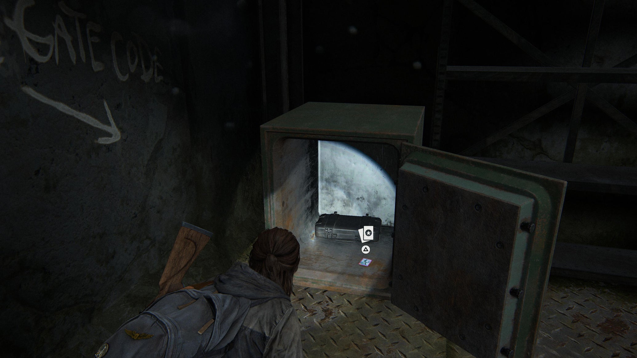 Ellie collecting loot from an open safe after inputting the combination in The Last of Us Part 2 Remastered on PS5 - 1