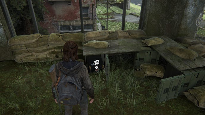 Ellie collecting a superhero trading card for her collection in The Last of Us Part 2 Remastered on PS5