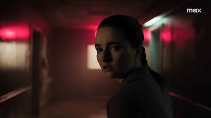 Abby looking concerned in a dimly lit hospital corridor in The Last of Us season 2.