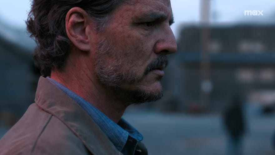 Pedro Pascal successful  The Last of Us play   2 arsenic  Joel, helium  is stood with a concerned, bittersweet  look  connected  his face.