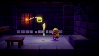 Zelda is stood talking to a floating, sentient orb of some kind, a staff floating in front of her in The Legend of Zelda: Echoes of Wisdom.