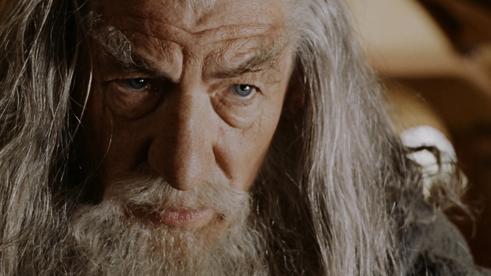 A close-up of Ian McKellen as Gandalf in The Lord of the Rings with a serious expression on his face. - 1