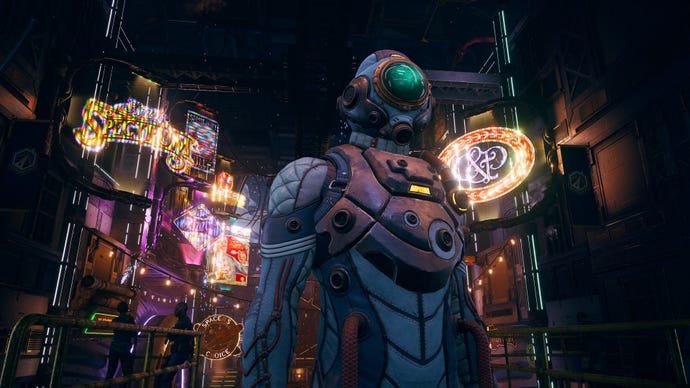 Someone in a futuristic spacesuit that kind of looks like a diving suit stands in front of a lot of holo-neon signs in a space station, in The Outer World’s: Spacer’s Choice Edition