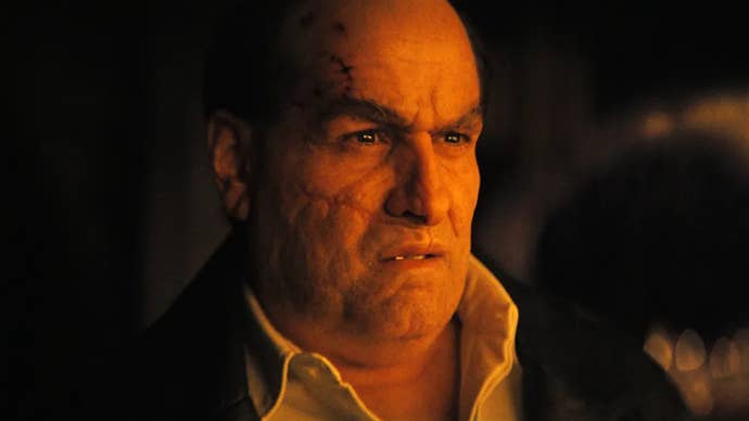 Colin Farrell as Oswald Cobblepot in The Penguin, a warm light is hitting his face, he’s looking slightly disgruntled about something.