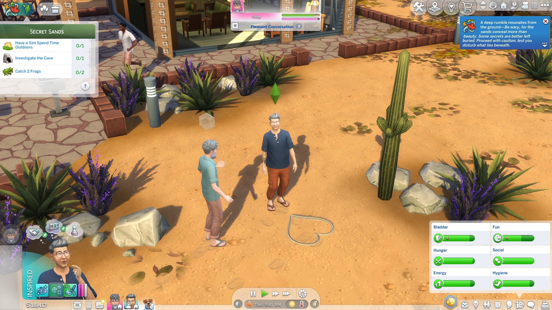 Two elderly male Sims draw hearts in the sand of a desert park area, with cactus plants and rocks nearby and a stone building visible in the background. - 5