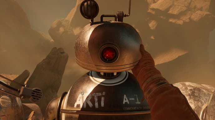 A screenshot from The Invincible, in which we see in first-person as the player reaches out to touch the domed head of a chrome robot in front of us.