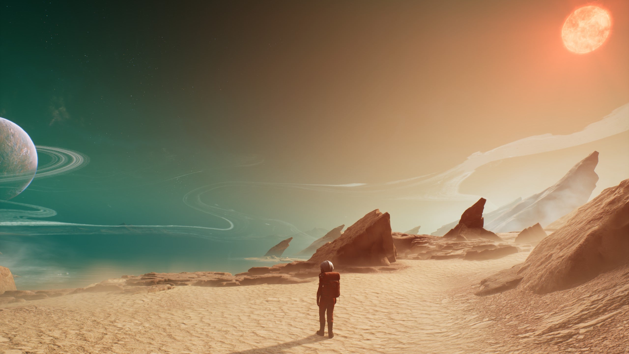 A screenshot showing the photo mode in The Invincible. We see a zoomed out image of an astronaut standing on a sandy path near the edge of a rocky cliff. In the distance, a ringed planet can be seen in the turquoise night sky. On the other side of the picture, we see a boiling orange sun. The two colour hues are almost in competition with each other. It&rsquo;s very pretty.