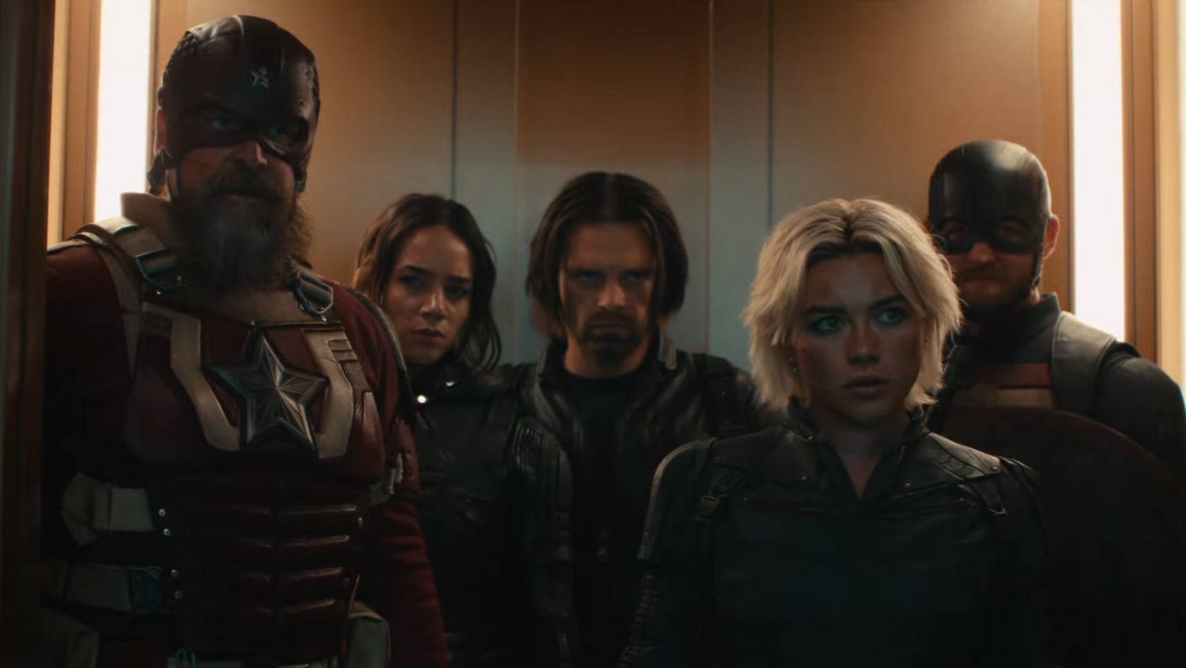 Some of the cast of Thunderbolts stood in an elevator, they all have a sour expression on their faces. - 1