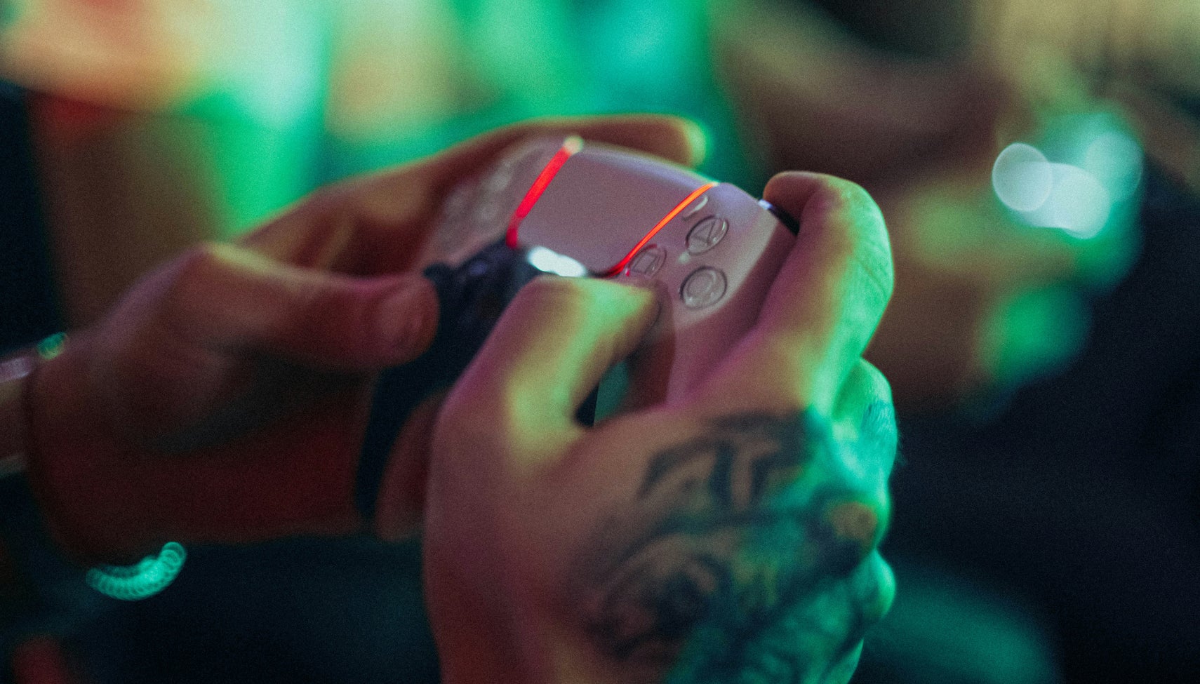 Person holding PlayStation 5 controller