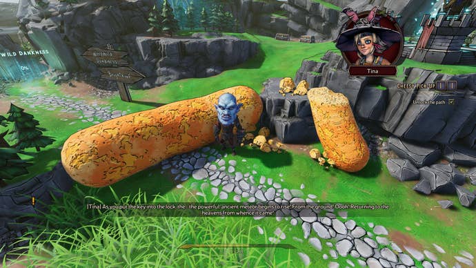 A small man with a large blue head stands next to a giant cheeso on a game board in Tiny Tina’s Wonderlands