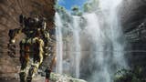 A pilot in red walks alongside their mechanical Titan. They are headed underneath a high waterfall - breaks in the water reveal a path behind the waterfall