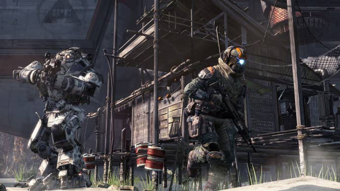 A soldier runs away from a mech in Titanfall
