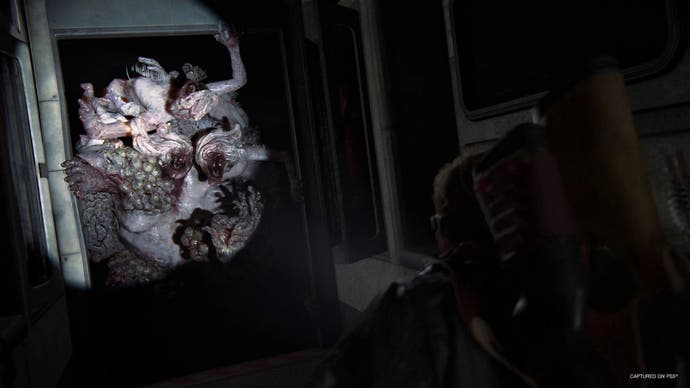 A giant mutant bursts through a door in The Last of Us Part 2 remastered.