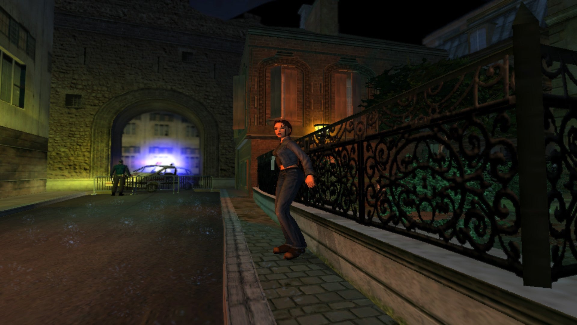 Lara Croft tries to hide against a fence in a Victorian-looking English street. In the distance, sirens.