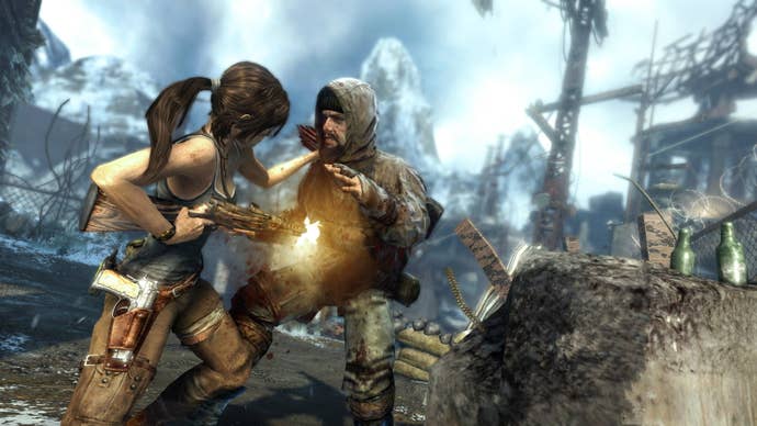 Lara Croft shoots a man in the gut at point blank range in a screen from the 2013 Tomb Raider reboot