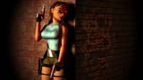 A Tomb Raider 2 render of Lara Croft, in iconic green top and brown hot pants, backed up against the corner of a wall, gun at the ready.