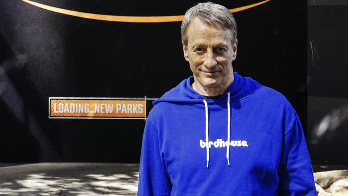 Image of skateboarder Tony Hawk in front of poster reading “loading…new parks”