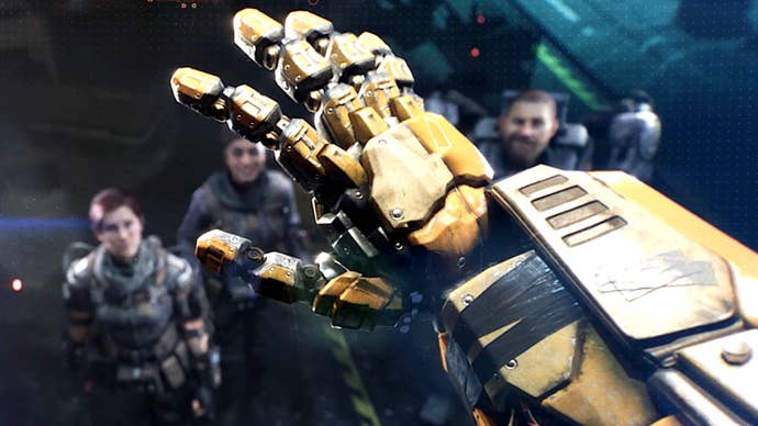 A Transformers: Reactivate promotional image showing a first-person view of a robotic hand being raised while a group of soldiers look on in the background.