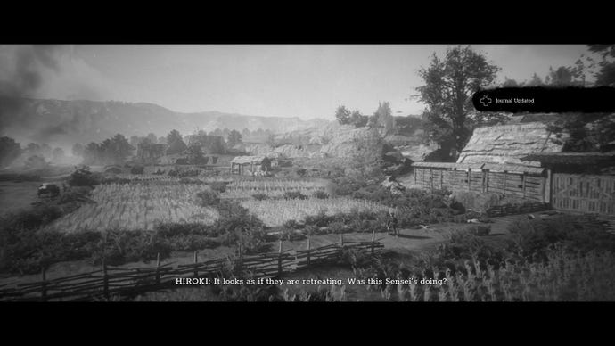 A screenshot from Trek To Yomi which shows a young Hiroki stands amidst a huge rice field, as mountains rise in the distance.
