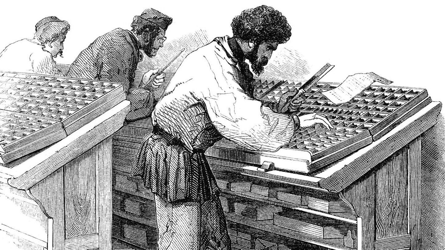 A compositor is leaning over the lower case with a composing stick in his left hand, about to pick up a character to fill in a line of type.