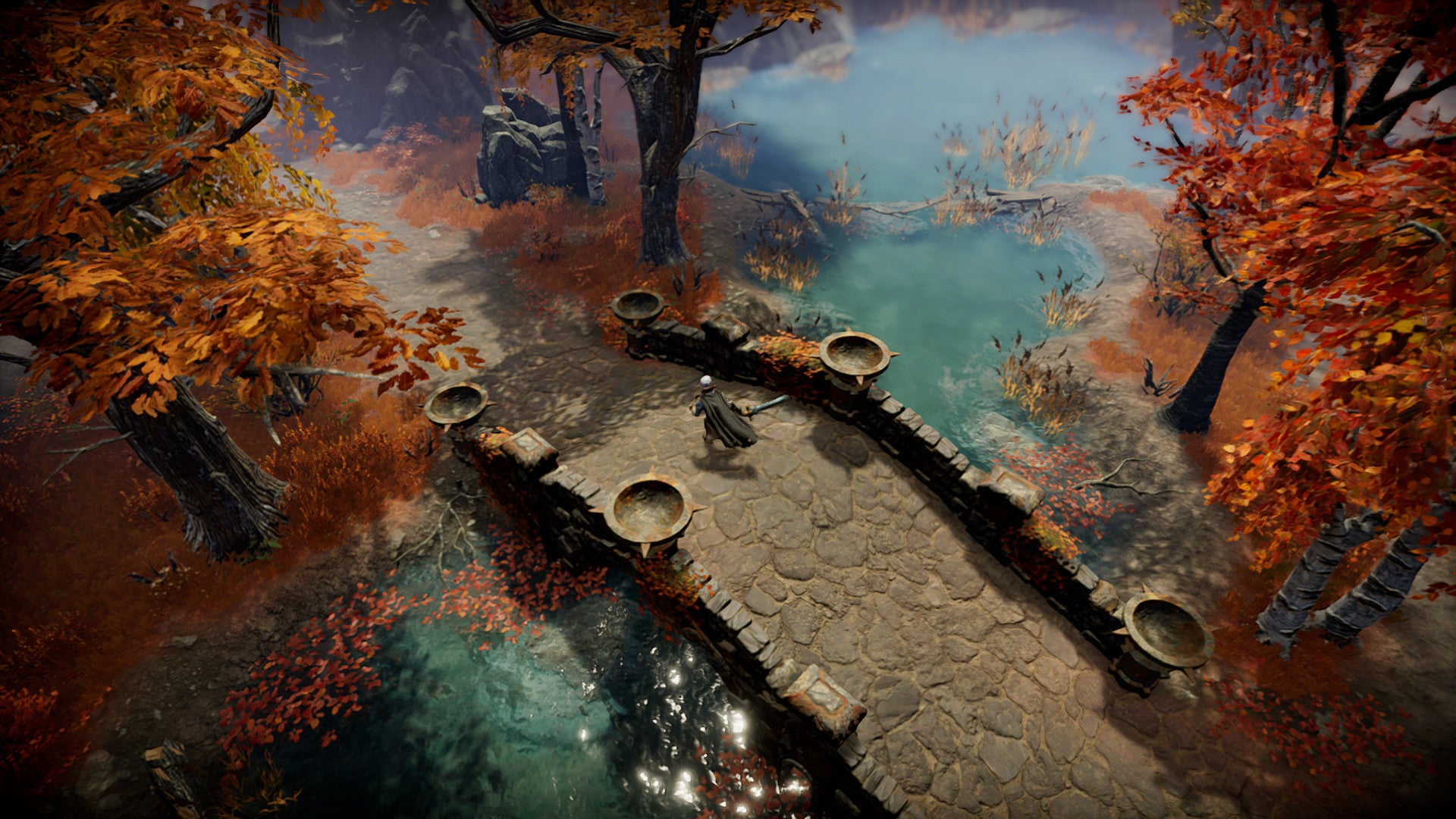 A player in V Rising crosses a bridge over a river surrounded by auburn-coloured trees. - 7