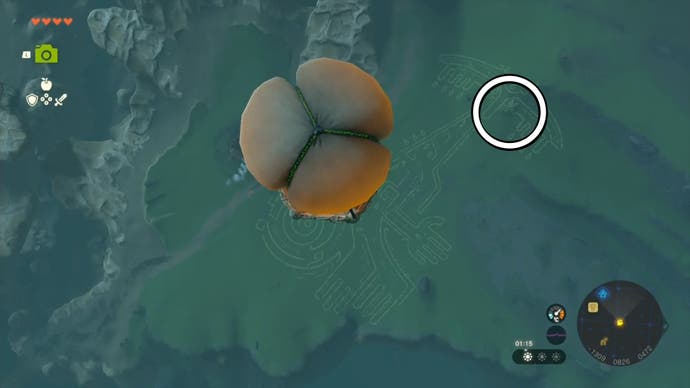 Link flying in Impa's hot air balloon with an area on the ground highlighted that players need to head to to complete the quest.