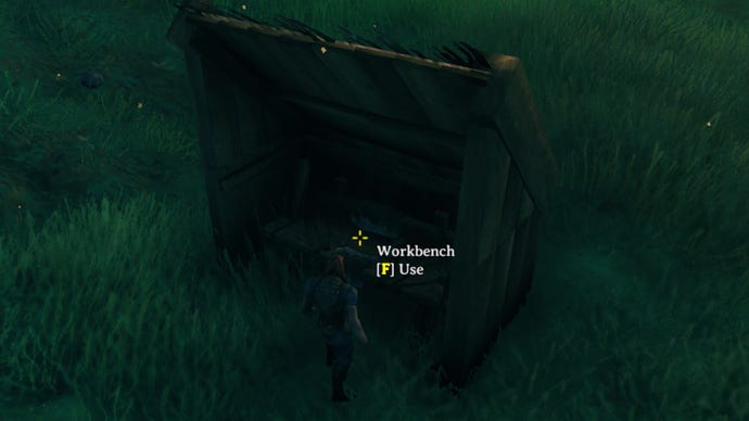 A Valheim screenshot of a fully covered and useable Workbench surrounded by 4 Wooden Walls and topped with two roof tiles and two triangle wall tiles.