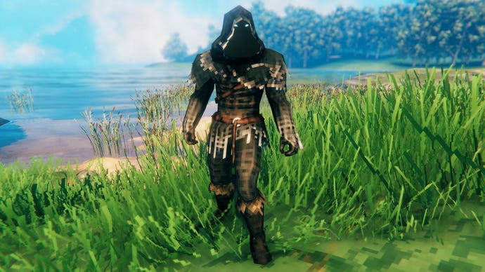 A player in Valheim stands on a Meadows coast and faces the camera wearing Fenris armour.